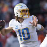 Los Angeles Chargers quarterback Justin Herbert (10) throws against the Denver Broncos during the first half of an NFL football game in Denver, Sunday, Jan. 8, 2023. (AP Photo/David Zalubowski)