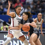 
              Georgetown's Kelsey Ransom, right, dribbles around UConn's Azzi Fudd, left, in the first half of an NCAA college basketball game, Sunday, Jan. 15, 2023, in Hartford, Conn. (AP Photo/Jessica Hill)
            