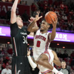 Houston guard Marcus Sasser (0) drives to the basket as Cincinnati forward Viktor Lakhin defends during the second half of an NCAA college basketball game, Saturday, Jan. 28, 2023, in Houston. (AP Photo/Eric Christian Smith)