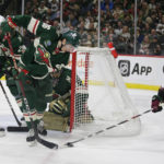Arizona Coyotes center Nick Schmaltz (8) controls the puck in front of Minnesota Wild center Connor Dewar (26) during the second period of an NHL hockey game Saturday, Jan. 14, 2023, in St. Paul, Minn. (AP Photo/Andy Clayton-King)