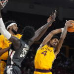 Arizona State guard Desmond Cambridge Jr. (4) grabs a rebound behind Washington State forward Mouhamed Gueye (35) and Arizona State forward Warren Washington, left, during the first half of an NCAA college basketball game in Tempe, Ariz., Thursday, Jan. 5, 2023. (AP Photo/Ross D. Franklin)