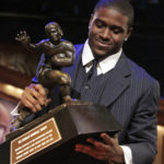 
              FILE - Southern California tailback Reggie Bush picks up the Heisman Trophy after being announced as the winner of the award Saturday, Dec. 10, 2005, in New York. Reggie Bush, whose Heisman Trophy victory for Southern California in 2005 was vacated because of NCAA violations, was among 18 players in the latest College Football Hall of Fame class announced Monday. (AP Photo/Julie Jacobson, File)
            