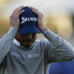 
              Sam Ryder adjusts his hat after finishing on the 18th hole of the South Course at Torrey Pines during the third round of the Farmers Insurance Open golf tournament, Friday, Jan. 27, 2023, in San Diego. (AP Photo/Gregory Bull)
            
