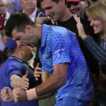 
              Novak Djokovic of Serbia celebrates in the stands with his support team after defeating Stefanos Tsitsipas of Greece in the men's singles final at the Australian Open tennis championship in Melbourne, Australia, Sunday, Jan. 29, 2023. (AP Photo/Aaron Favila)
            