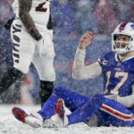 Buffalo Bills quarterback Josh Allen (17) reacts after taking a hit from the Cincinnati Bengals during the fourth quarter of an NFL division round football game, Sunday, Jan. 22, 2023, in Orchard Park, N.Y. (AP Photo/Joshua Bessex)