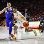 Tennessee guard Santiago Vescovi (25) drives against Kentucky guard CJ Fredrick (1) during the first half of an NCAA college basketball game Saturday, Jan. 14, 2023, in Knoxville, Tenn. (AP Photo/Wade Payne)