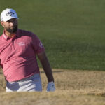 Jon Rahm reacts after his shot from a bunker off the fairway on the 18th hole during the final round of the American Express golf tournament on the Pete Dye Stadium Course at PGA West Sunday, Jan. 22, 2023, in La Quinta, Calif. (AP Photo/Mark J. Terrill)