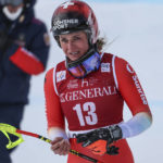 
              Switzerland's Corinne Suter gets to the finish area after crashing during an alpine ski, women's World Cup downhill race, in Cortina d'Ampezzo, Italy, Friday, Jan. 20, 2023. (AP Photo/Alessandro Trovati)
            