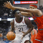 
              UConn's Adama Sanogo (21) looks to shoot as St. John's Joel Soriano defends in the first half of an NCAA college basketball game, Sunday, Jan. 15, 2023, in Hartford, Conn. (AP Photo/Jessica Hill)
            