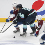 
              Colorado Avalanche center Alex Newhook (18) and Seattle Kraken center Matty Beniers (10) compete for the puck during the first period of an NHL hockey game Saturday, Jan. 21, 2023, in Seattle. (AP Photo/Lindsey Wasson)
            