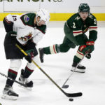 Arizona Coyotes left wing Nick Ritchie (12) controls the puck in front of Minnesota Wild defenseman Calen Addison (2) in the first period during an NHL hockey game Saturday, Jan. 14, 2023, in St. Paul, Minn. (AP Photo/Andy Clayton-King)