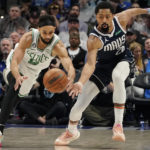 Boston Celtics guard Derrick White (9) and Dallas Mavericks guard Spencer Dinwiddie (26) chase the ball during the second half of an NBA basketball game in Dallas, Thursday, Jan. 5, 2023. (AP Photo/LM Otero)