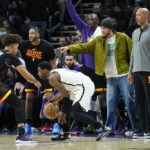 Brooklyn Nets guard Kyrie Irving looks to pass as Phoenix Suns forward Cameron Johnson (23) defends during the second half of an NBA basketball game, Thursday, Jan. 19, 2023, in Phoenix. (AP Photo/Matt York)