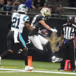 New Orleans Saints wide receiver Chris Olave scores ahead of Carolina Panthers safety Jeremy Chinn during the first half an NFL football game between the Carolina Panthers and the New Orleans Saints in New Orleans, Sunday, Jan. 8, 2023. (AP Photo/Gerald Herbert)