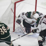 Arizona Coyotes goaltender Connor Ingram (39) blocks a shot by Minnesota Wild right wing Mats Zuccarello (36) with defensive help from Shayne Gostisbehere (14) during the first period of an NHL hockey game Saturday, Jan. 14, 2023, in St. Paul, Minn. (AP Photo/Andy Clayton-King)