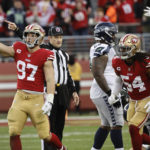 San Francisco 49ers defensive end Nick Bosa (97) celebrates after recovering a fumble during the second half of an NFL wild card playoff football game against the Seattle Seahawks in Santa Clara, Calif., Saturday, Jan. 14, 2023. (AP Photo/Josie Lepe)