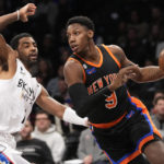 
              New York Knicks guard RJ Barrett (9) drives against Brooklyn Nets guard Kyrie Irving during the first half of an NBA basketball game, Saturday, Jan. 28, 2023, in New York. (AP Photo/Mary Altaffer)
            