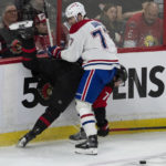 
              Montreal Canadiens center Kirby Dach, top, collides with Ottawa Senators defenseman Thomas Chabot along the boards during second-period NHL hockey game action Saturday, Jan. 28, 2023, in Ottawa, Ontario. (Adrian Wyld/The Canadian Press via AP)
            