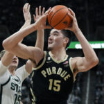 Purdue center Zach Edey (15) attempts a shot as Michigan State center Carson Cooper (15) defends during the first half of an NCAA college basketball game, Monday, Jan. 16, 2023, in East Lansing, Mich. (AP Photo/Carlos Osorio)