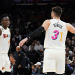 Miami Heat guard Max Strus (31) celebrates his score against the Phoenix Suns wtih guard Victor Oladipo, left, during the second half of an NBA basketball game in Phoenix, Friday, Jan. 6, 2023. The Heat won 104-96. (AP Photo/Ross D. Franklin)