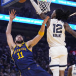 
              Memphis Grizzlies guard Ja Morant, right, blocks a shot by Golden State Warriors forward Klay Thompson during the first half of an NBA basketball game in San Francisco, Wednesday, Jan. 25, 2023. (AP Photo/Godofredo A. Vásquez)
            