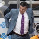 Pittsburgh Penguins head coach Mike Sullivan stands behind his bench during the overtime period of an NHL hockey game against the Florida Panthers in Pittsburgh, Tuesday, Jan. 24, 2023. The Penguins won 7-6 in overtime. (AP Photo/Gene J. Puskar)