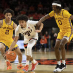 Oregon State guard Jordan Pope, center, dribbles between Arizona State's Austin Nunez (2) and DJ Horne, right, during the first half of an NCAA college basketball game in Corvallis, Ore., Saturday, Jan. 14, 2023. (AP Photo/Amanda Loman)