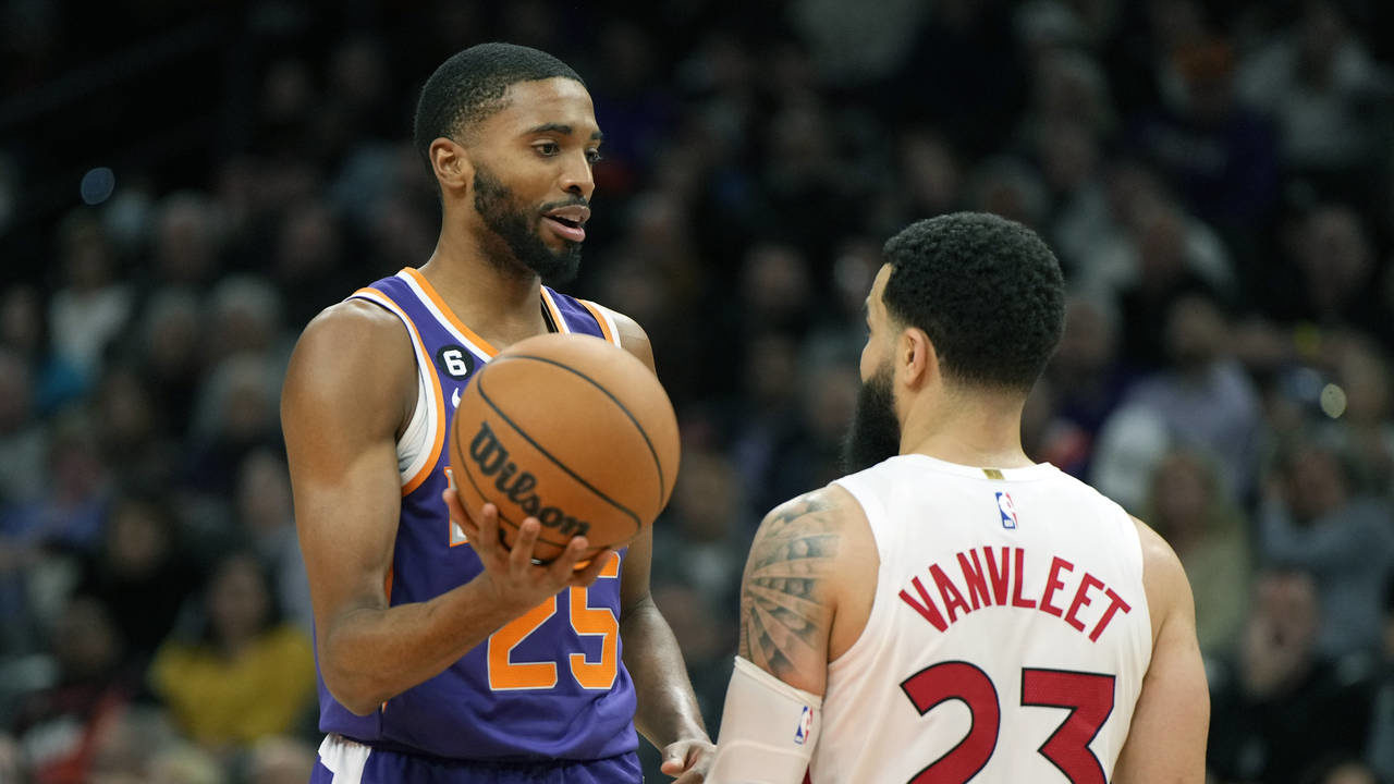 Phoenix Suns forward Mikal Bridges, left, talks to Toronto Raptors guard Fred VanVleet (23) during ...