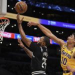 Los Angeles Clippers forward Norman Powell, left shoots as Los Angeles Lakers guard Max Christie defends during the first half of an NBA basketball game Tuesday, Jan. 24, 2023, in Los Angeles. (AP Photo/Mark J. Terrill)