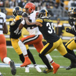 Cleveland Browns quarterback Deshaun Watson is tackled by Pittsburgh Steelers safety Minkah Fitzpatrick and cornerback James Pierre during the second half of an NFL football game in Pittsburgh, Sunday, Jan. 8, 2023. (AP Photo/Don Wright)