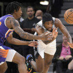 San Antonio Spurs' Blake Wesley, right, and Phoenix Suns' Saben Lee chase the ball during the first half of an NBA basketball game, Saturday, Jan. 28, 2023, in San Antonio. (AP Photo/Darren Abate)