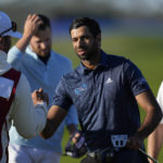 
              Aaron Rai, center, of England, shakes hands after finishing on the ninth hole of the North Course at Torrey Pines during the first round of the Farmers Insurance Open golf tournament Wednesday, Jan. 25, 2023, in San Diego. (AP Photo/Gregory Bull)
            