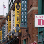 Boston Bruins and Pittsburgh Penguins banners are displayed on the facade of Fenway Park prior to the NHL Winter Classic hockey game, Monday, Jan. 2, 2023, in Boston. (AP Photo/Charles Krupa)