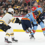 Florida Panthers defenseman Brandon Montour (62) collides with center Sam Reinhart as he chases the puck with Boston Bruins center Pavel Zacha (18) during the first period of an NHL hockey game, Saturday, Jan. 28, 2023, in Sunrise, Fla. (AP Photo/Wilfredo Lee)