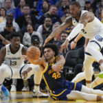 Golden State Warriors forward Anthony Lamb, middle, passes the ball away from Memphis Grizzlies forward Xavier Tillman Sr., right, during the second half of an NBA basketball game in San Francisco, Wednesday, Jan. 25, 2023. (AP Photo/Godofredo A. Vásquez)