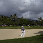 
              Si Woo Kim watches his shot from the bunker along the 18th fairway during the final round of the Sony Open golf tournament, Sunday, Jan. 15, 2023, at Waialae Country Club in Honolulu. (AP Photo/Matt York)
            