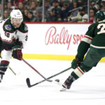 Arizona Coyotes center Liam O'Brien (38) and Minnesota Wild defenseman Matt Dumba (24) vie for the puck in the second period during an NHL hockey game Saturday, Jan. 14, 2023, in St. Paul, Minn. (AP Photo/Andy Clayton-King)