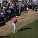 Jon Rahm chips to the 8th green during the final round of the American Express golf tournament on the Pete Dye Stadium Course at PGA West Sunday, Jan. 22, 2023, in La Quinta, Calif. (AP Photo/Mark J. Terrill)