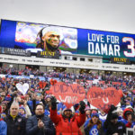 
              FILE - Fans stand in support for Buffalo Bills safety Damar Hamlin (3) before an NFL football game against the New England Patriots, Sunday, Jan. 8, 2023, in Orchard Park, N.Y. Damar Hamlin plans to support young people through education and sports with the $8.6 million in GoFundMe donations that unexpectedly poured into his toy drive fundraiser after he suffered a cardiac arrest in the middle of a game last week. (AP Photo/Adrian Kraus, File)
            