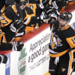 Pittsburgh Penguins' Jason Zucker (16) returns to the bench after scoring during the first period of an NHL hockey game against the Anaheim Ducks in Pittsburgh, Monday, Jan. 16, 2023. (AP Photo/Gene J. Puskar)