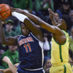 Arizona center Oumar Ballo (11) is pressured by Oregon guard Jermaine Couisnard during the first half of an NCAA college basketball game Saturday, Jan. 14, 2023, in Eugene, Ore. (AP Photo/Andy Nelson)