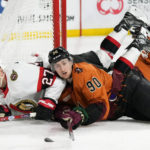 Arizona Coyotes defenseman J.J. Moser (90) collides with Ottawa Senators center Dylan Gambrell (27) during the second period of an NHL hockey game in Tempe, Ariz., Thursday, Jan. 12, 2023. (AP Photo/Ross D. Franklin)