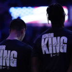 Indiana Pacers' Bennedict Mathurin, right, and T.J. McConnell, left, wear shirts honoring Martin Luther King Jr. during the National Anthem before an NBA basketball game against the Milwaukee Bucks, Monday, Jan. 16, 2023, in Milwaukee. (AP Photo/Aaron Gash)