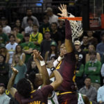Arizona State forward Warren Washington, top right, reaches through the net to try and block a shot byOregon forward Quincy Guerrier, second from left, as Arizona State guard Desmond Cambridge Jr. (4) helps defend on the play during the first half of an NCAA college basketball game Thursday, Jan. 12, 2023, in Eugene, Ore. (AP Photo/Andy Nelson)