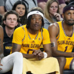 Arizona State forward Alonzo Gaffney, left, guard DJ Horne (0) and guard Luther Muhammad (1) watch the closing moments of the team's loss to Southern California in an NCAA college basketball game in Tempe, Ariz., Saturday, Jan. 21, 2023. (AP Photo/Ross D. Franklin)