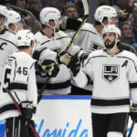 
              Los Angeles Kings center Phillip Danault, right, celebrates with the bench after his goal against the Tampa Bay Lightning during the second period of an NHL hockey game Saturday, Jan. 28, 2023, in Tampa, Fla. (AP Photo/Chris O'Meara)
            