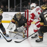 Vegas Golden Knights goaltender Adin Hill (33) stops a shot by Detroit Red Wings center Robby Fabbri (14) during the first period of an NHL hockey game Thursday, Jan. 19, 2023, in Las Vegas. (AP Photo/John Locher)