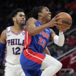 Detroit Pistons guard Jaden Ivey (23) attempts a layup as Philadelphia 76ers forward Tobias Harris (12) defends during the second half of an NBA basketball game, Sunday, Jan. 8, 2023, in Detroit. (AP Photo/Carlos Osorio)
