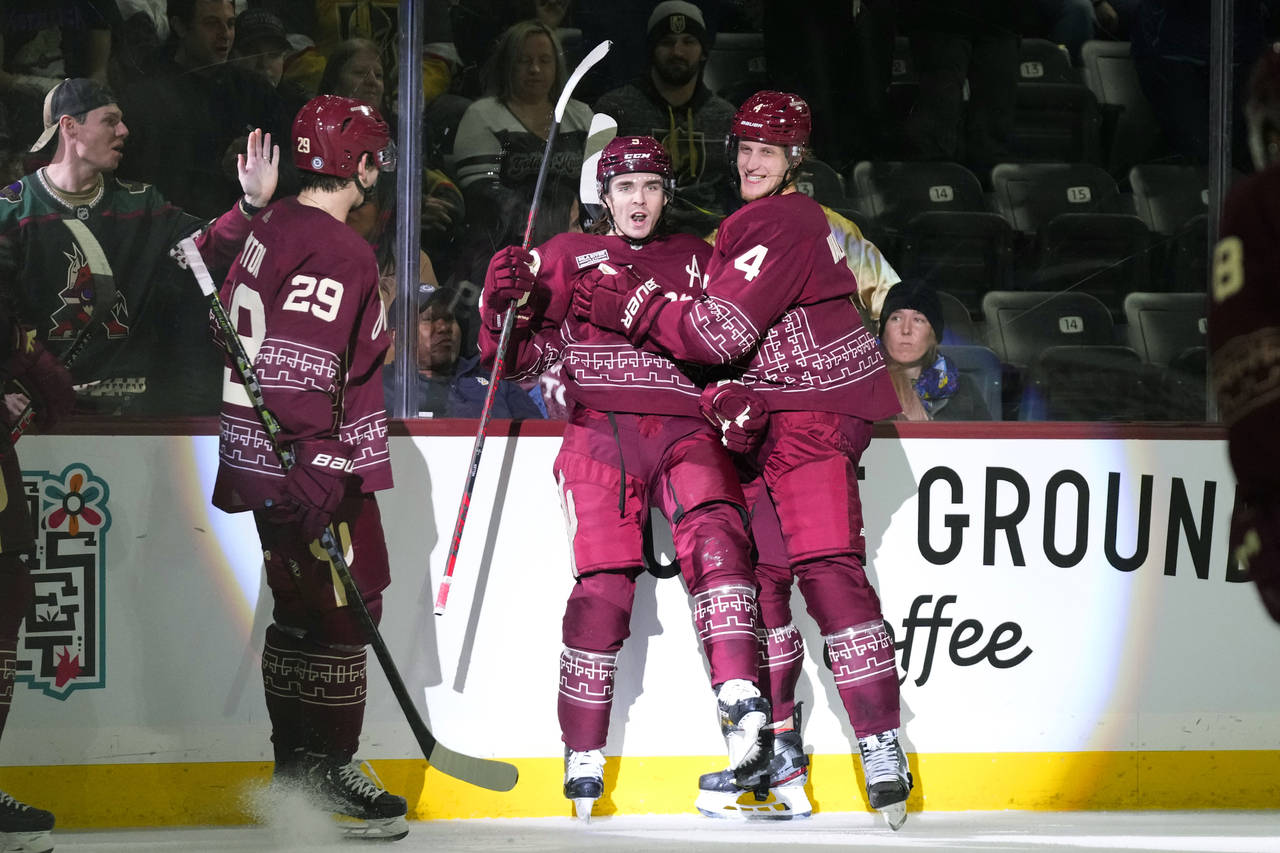 Arizona Coyotes right wing Clayton Keller, center, celebrates after his goal against the Vegas Gold...