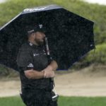 
              Shane Lowry of Ireland holds un umbrella before plays his third shot on the 3rd hole during his first round on Day Two of the Dubai Desert Classic, in Dubai, United Arab Emirates, Friday, Jan. 27, 2023. (AP Photo/Kamran Jebreili)
            
